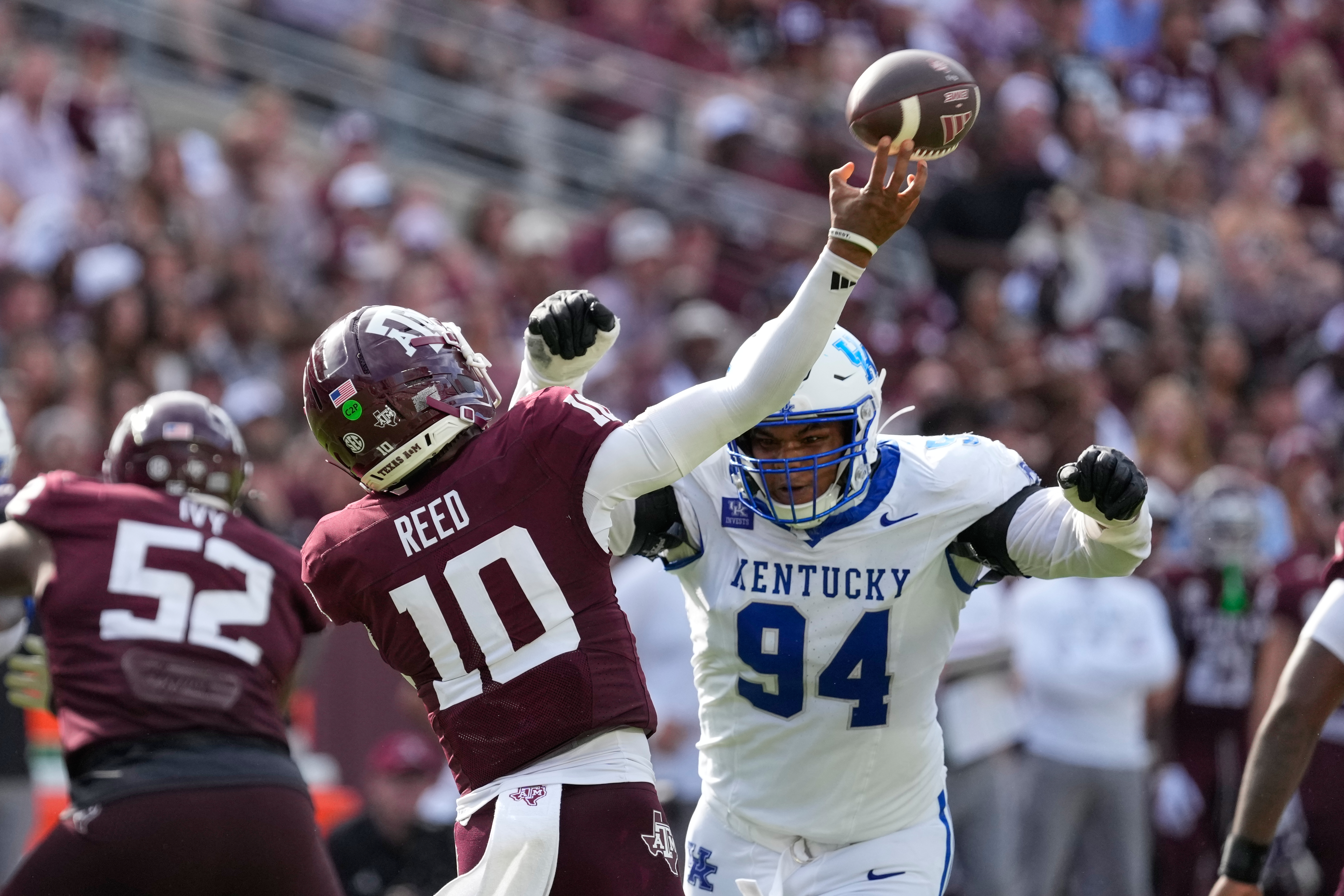 Texas A&M quarterback Marcel Reed (10) is pressured by Kentucky defensive lineman Tavion Gadson (94) during the second half of an NCAA college football game Saturday, Sept. 19, 2026, in College Station, Texas. 