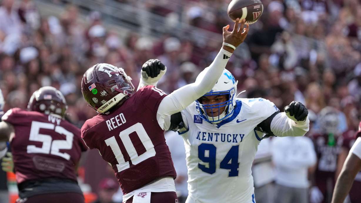 Texas A&M quarterback Marcel Reed (10) is pressured by Kentucky defensive lineman Tavion Gadson (94) during the second half of an NCAA college football game Saturday, Sept. 19, 2026, in College Station, Texas.