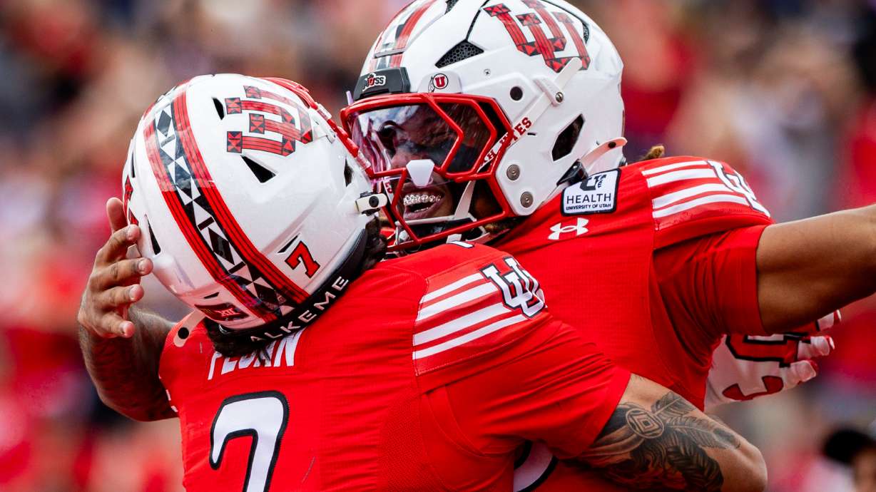 Utah Utes quarterback Byrd Ficklin (15), right, celebrates with Utah Utes wide receiver Braden Pegan (7), left, after Ficklin scored a touchdown during a football game against the Utah State Aggies at Rice-Eccles Stadium in Salt Lake City on Saturday, Sept. 19, 2026.