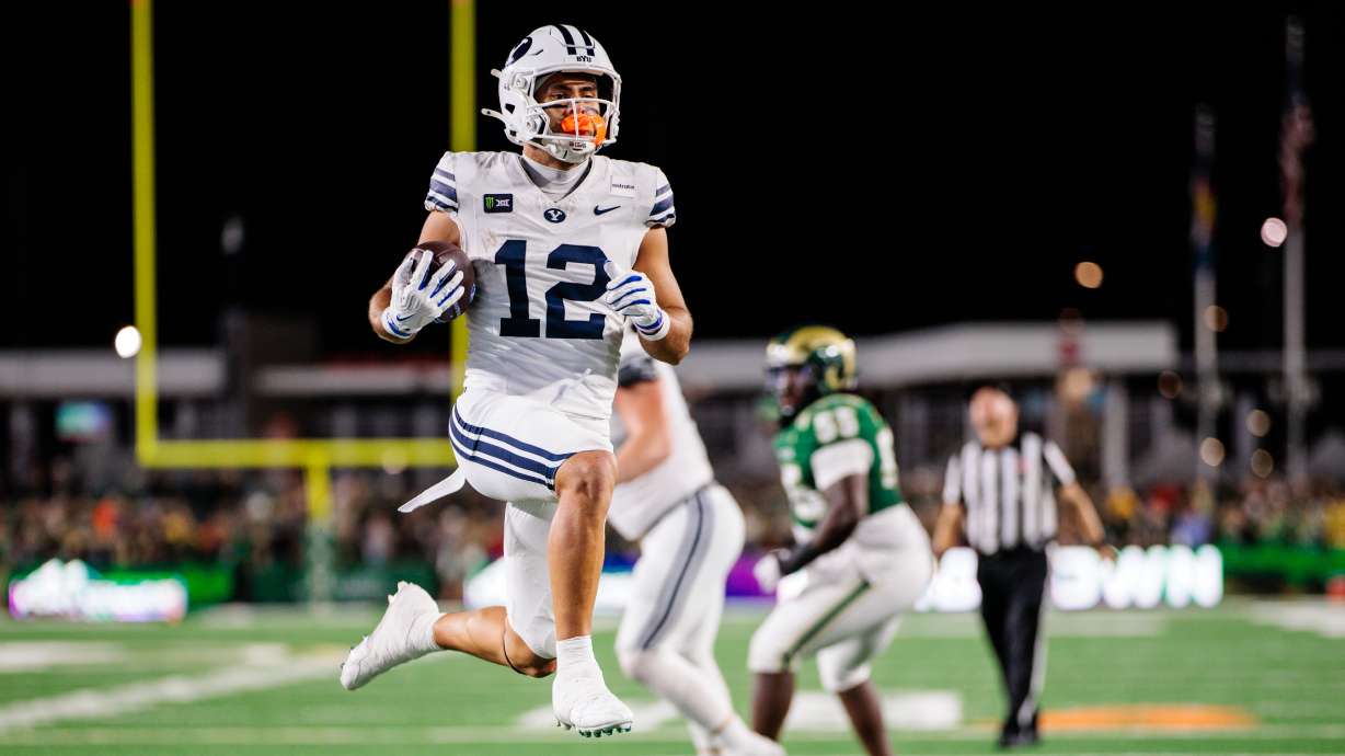 Preston Rex (12) of the BYU Cougars jumps into the end zone for a touchdown during the third quarter against the Colorado State Rams at Canvas Stadium on September 19, 2026 in Fort Collins, Colorado.