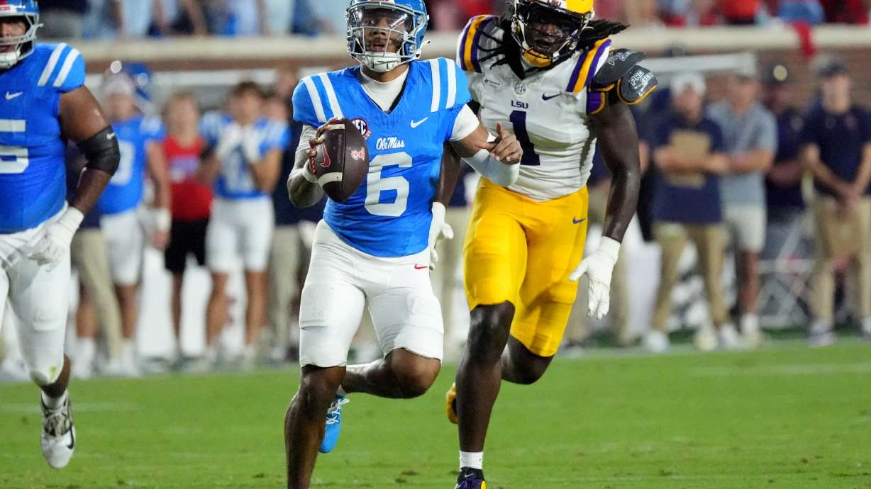Mississippi quarterback Trinidad Chambliss (6) is pursued by LSU defensive end Princewill Umanmielen (1) during the first half of an NCAA college football game in Oxford, Miss., Saturday, Sept. 19, 2026.