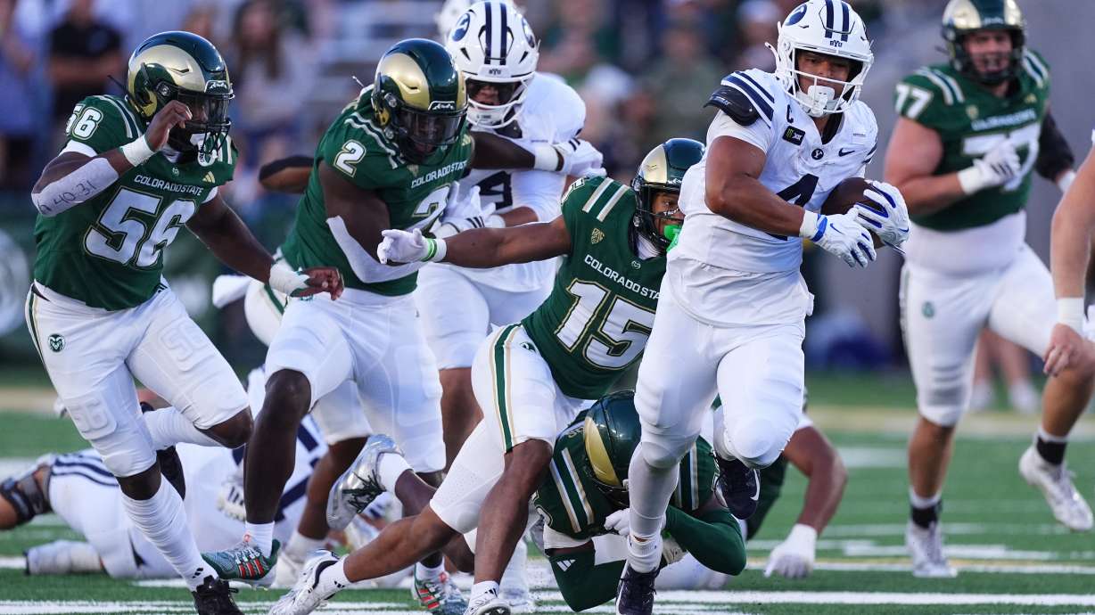 BYU running back Lj Martin, right, runs for a long touchdown as Colorado State safety Treshawn Moore, third from left, and linebacker Oumar Diomande and Kenyon Agurs, left, pursue in the first half of an NCAA college football game Saturday, Sept. 19, 2026, in Fort Collins, Colo.