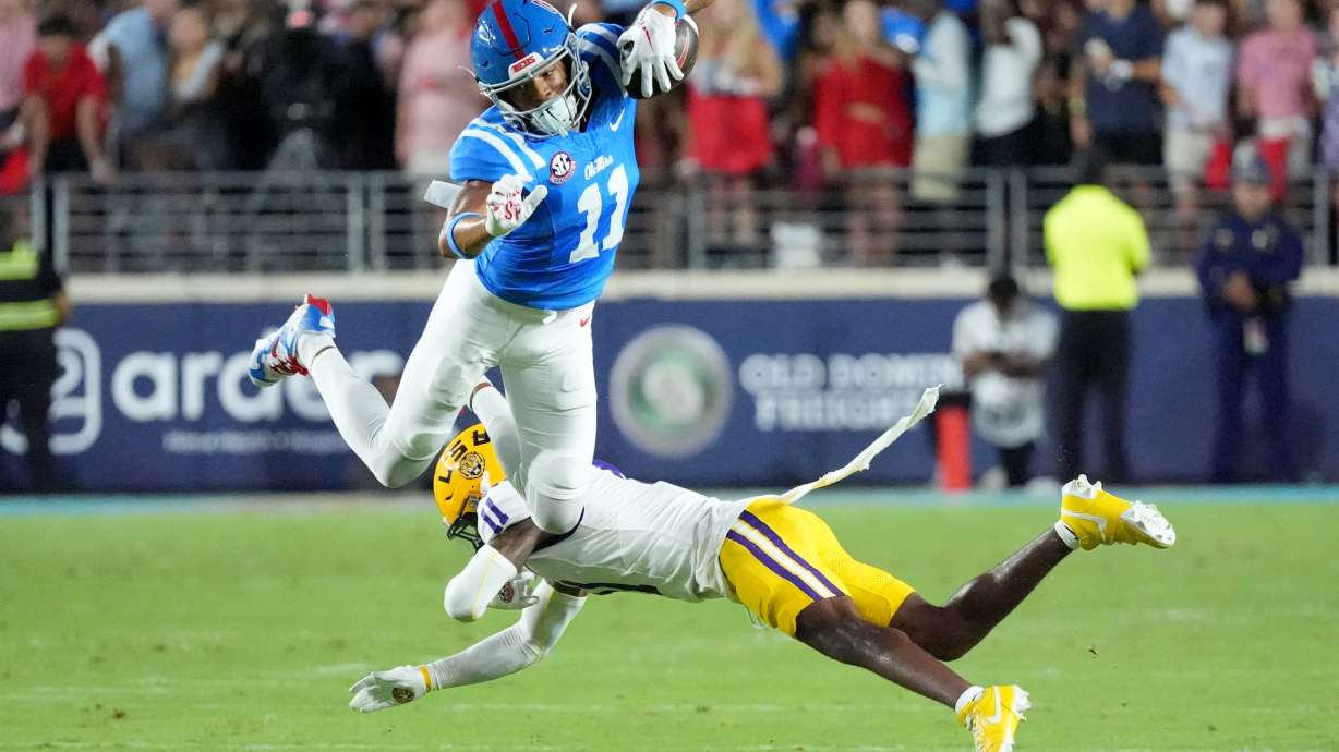 Mississippi wide receiver Horatio Fields (11) is upended by LSU cornerback PJ Woodland (11) during the first half of an NCAA college football game in Oxford, Miss., Saturday, Sept. 19, 2026.
