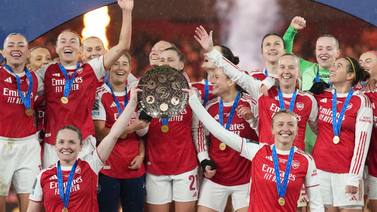 FILE - Arsenal's team captains Kin Little, left, and Leah Williamson, right, lift the trophy after winning the Women's Champions Cup final soccer match between Arsenal FC and SC Corinthians in London, Sunday, Feb. 1, 2026.