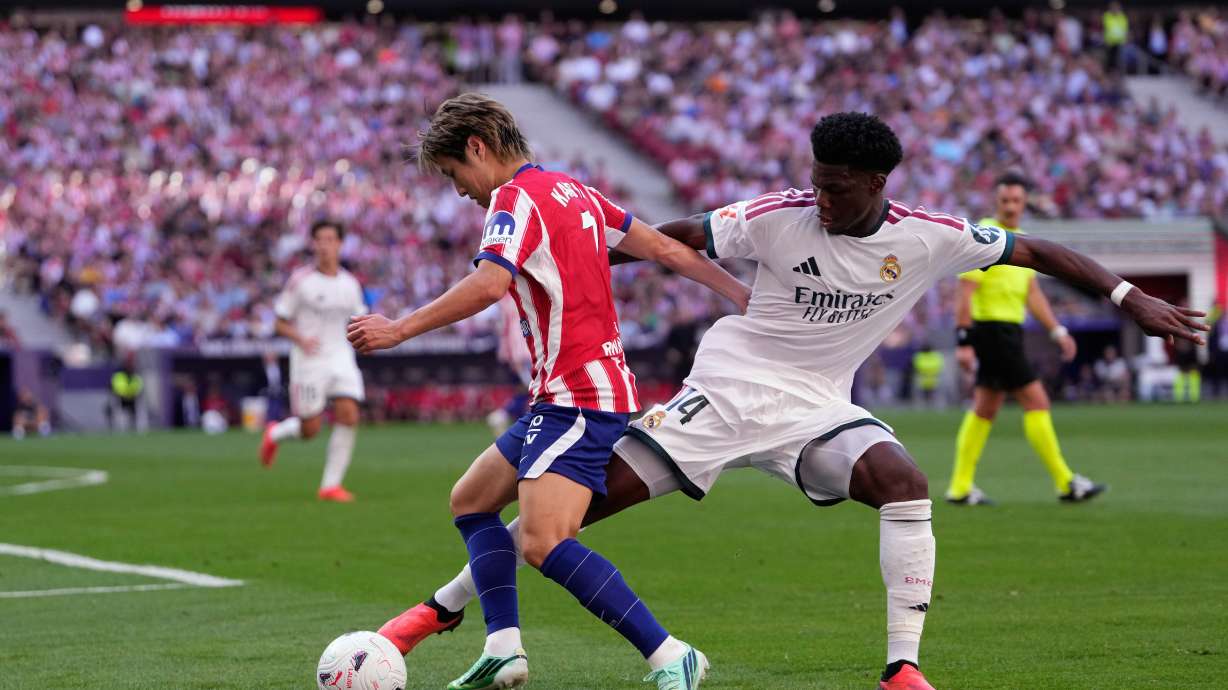 Atletico Madrid's Lee Kang-in tries to dribble the ball past Real Madrid's Aurelien Tchouameni, right, during a Spanish La Liga soccer match between Atletico Madrid and Real Madrid in Madrid, Sunday, Sept. 20, 2026.