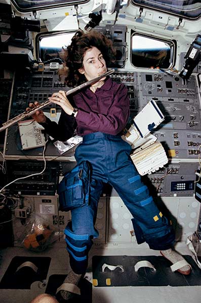 Ellen Ochoa, STS-56 mission specialist, takes a brief time out from a busy day in space to play a 15-minute set of flute music on the space shuttle Discovery’s aft flight deck. Ochoa, who has played the flute for years, performed the Marine Corps Hymn, Navy Hymn and God Save the Queen for fellow crew members, as well as some Vivaldi for herself.