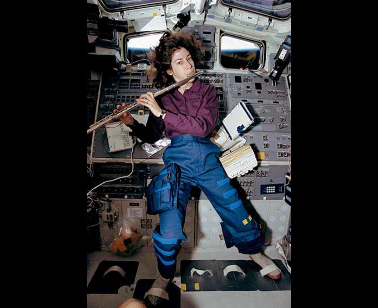 Ellen Ochoa, STS-56 mission specialist, takes a brief time out from a busy day in space to play a 15-minute set of flute music on the space shuttle Discovery’s aft flight deck. Ochoa, who has played the flute for years, performed the Marine Corps Hymn, Navy Hymn and God Save the Queen for fellow crew members, as well as some Vivaldi for herself.