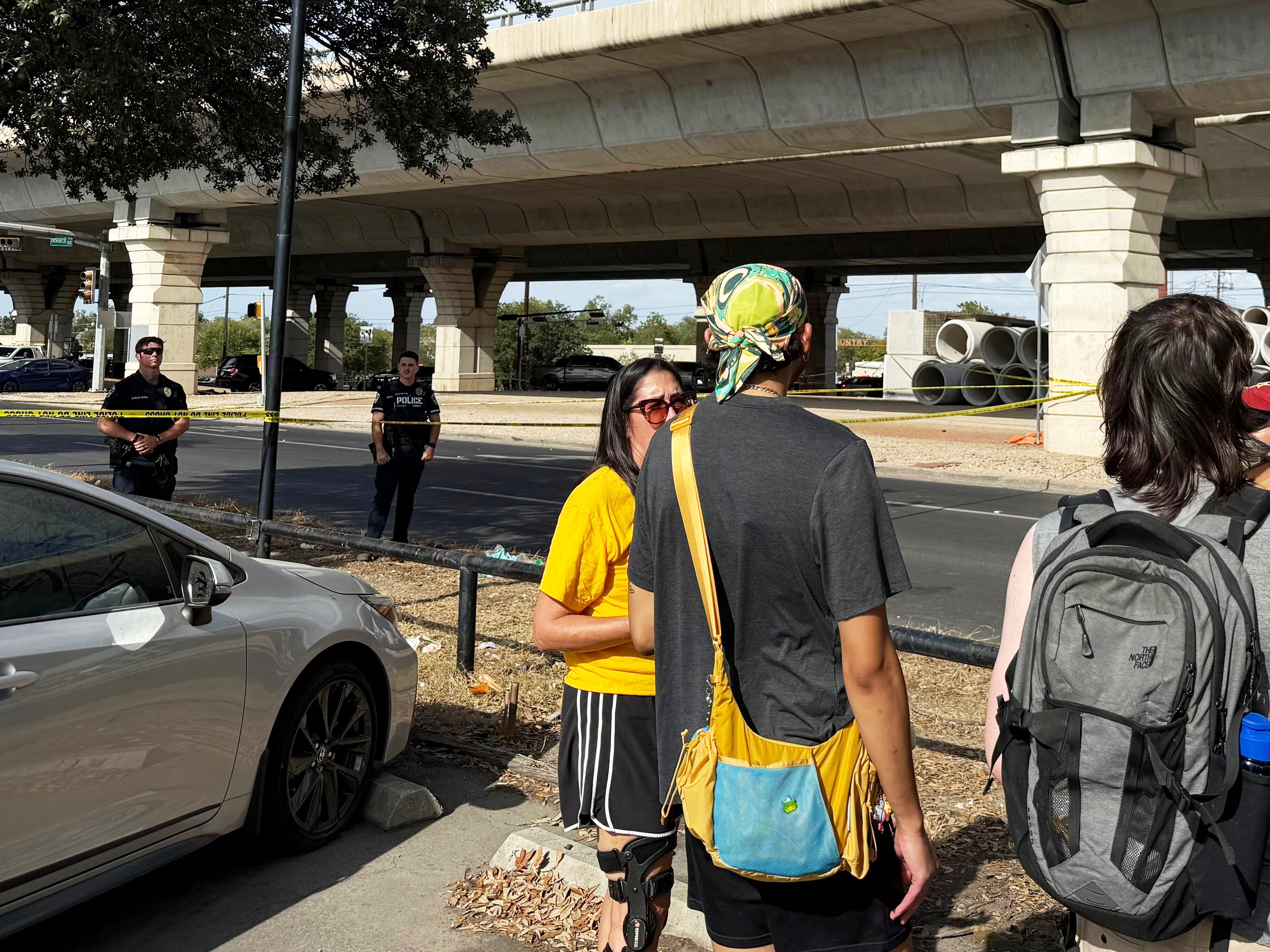 In this photo, taken with a smart phone Police block a street after a shooting involving an ICE officer in Austin, Texas, on Sunday.