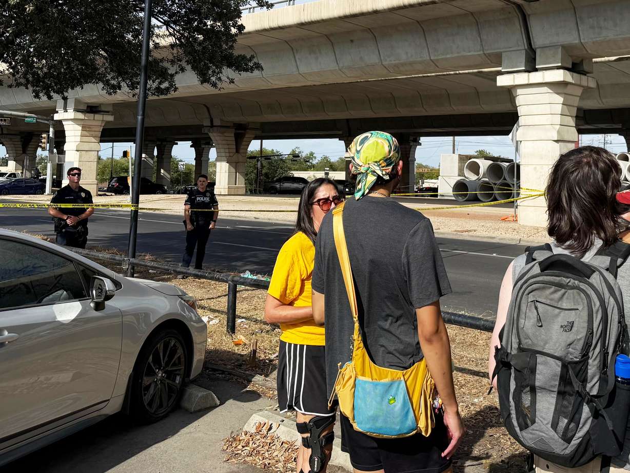 In this photo, taken with a smart phone Police block a street after a shooting involving an ICE officer in Austin, Texas, on Sunday.