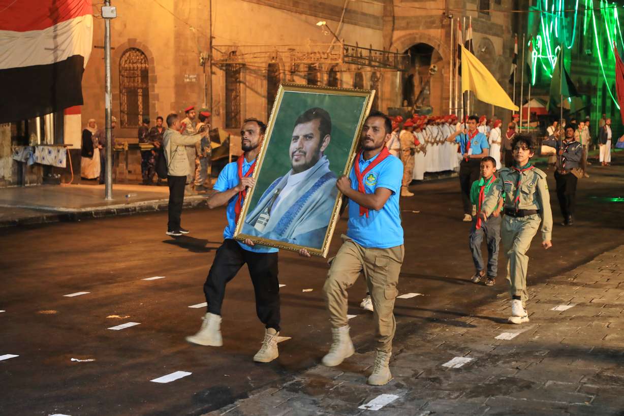 Supporters of Yemen's Houthi rebels march with a poster showing their leader Abdul Malik al-Houthi during a rally to mark the 12-year anniversary of the fall of Sanaa to the Houthis in Sanaa, Sept. 20. Three people were killed in Houthi attacks on Riyadh airport on Thursday.