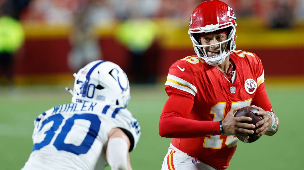 Kansas City Chiefs quarterback Patrick Mahomes (15) runs for a first down as Indianapolis Colts safety Hunter Wohler (30) defends during overtime of an NFL football game Sunday, Sept. 20, 2026, in Kansas City, Mo.