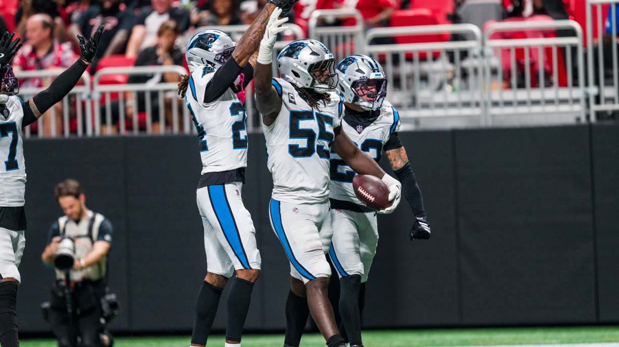 Carolina Panthers linebacker Devin Lloyd (55) celebrates a touchdown with cornerback Will Lee III (24) and safety Lathan Ransom (22) during an NFL football game against the Atlanta Falcons in Atlanta, Sunday, Sept. 20, 2026.
