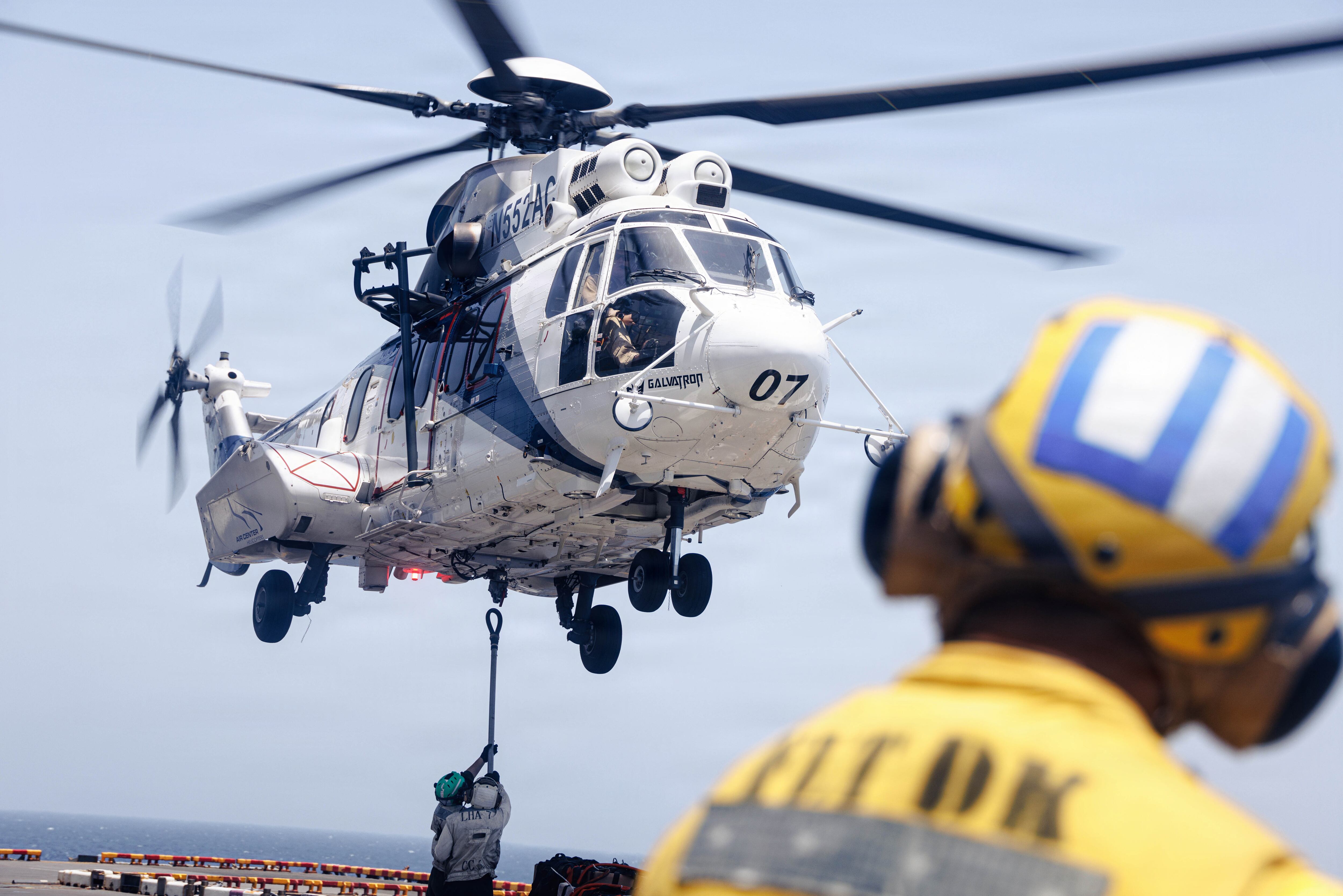 U.S. Sailors embarked aboard the forward-deployed amphibious assault ship USS Tripoli, attach supplies to an EC-255 Super Puma, assigned to the Maritime Pre-Positioning Force, during a vertical replenishment evolution in the U.S. Central Command area of responsibility, May 10. Tripoli is deployed to the U.S. 5th Fleet area of operations to support maritime security and stability in the Middle East.
