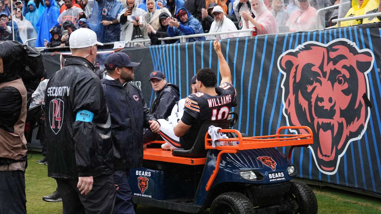 Chicago Bears quarterback Caleb Williams (18) waves as he is carted off the field after an injury during the second half of an NFL football game against the Minnesota Vikings in Chicago, Sunday, Sept. 20, 2026.