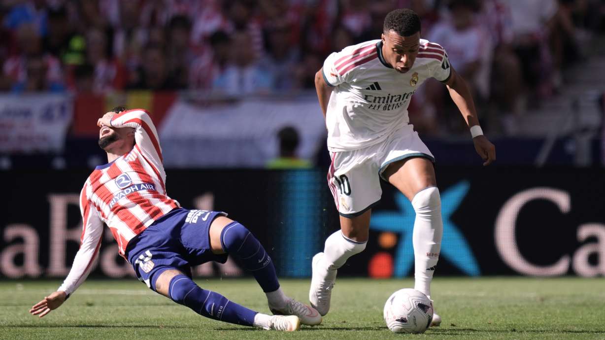 Atletico Madrid's Alex Baena falls to the ground in a clash with Real Madrid's Kylian Mbappe during a Spanish La Liga soccer match between Atletico Madrid and Real Madrid in Madrid, Sunday, Sept. 20, 2026.