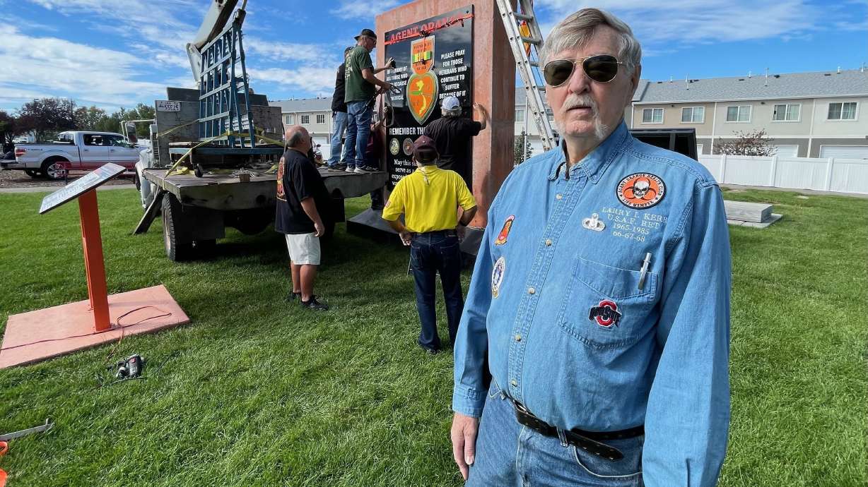 The Agent Orange memorial in Sunset sought by Syracuse Vietnam War veteran Larry Kerr is largely complete. Kerr is pictured Monday at the installation of the last black marble slab on the monument.