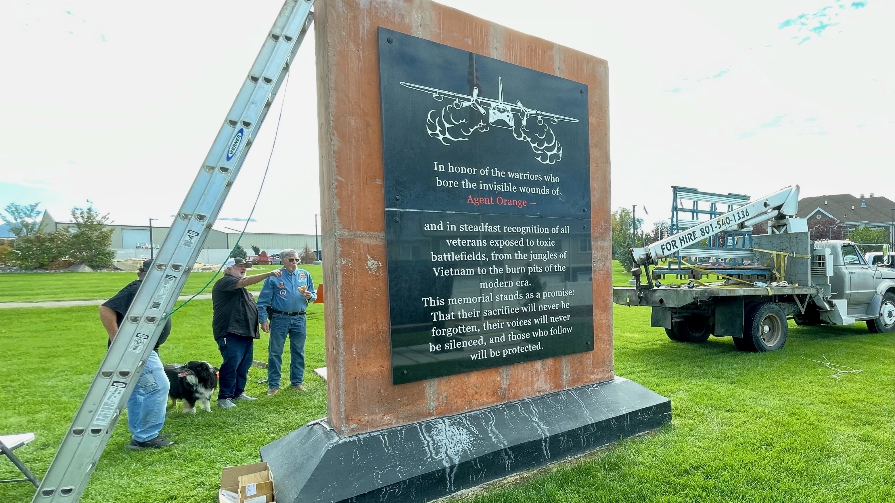 The Agent Orange memorial in Sunset sought by Syracuse Vietnam War veteran Larry Kerr is largely complete. Kerr, right, is pictured Monday at the installation of the last black marble slab on the opposite side of the monument.