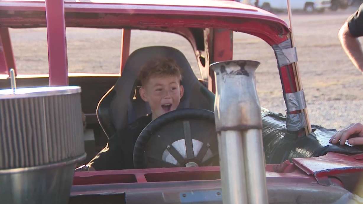 Silus Anderson, 12, rides in a demolition derby vehicle on the track at the Utah State Fairpark's Day of "Wreck"oning Demolition Derby.