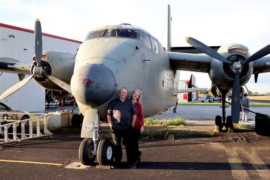 Corey and Erica Radford in front of the Caribou at the Legacy Flight Museum.