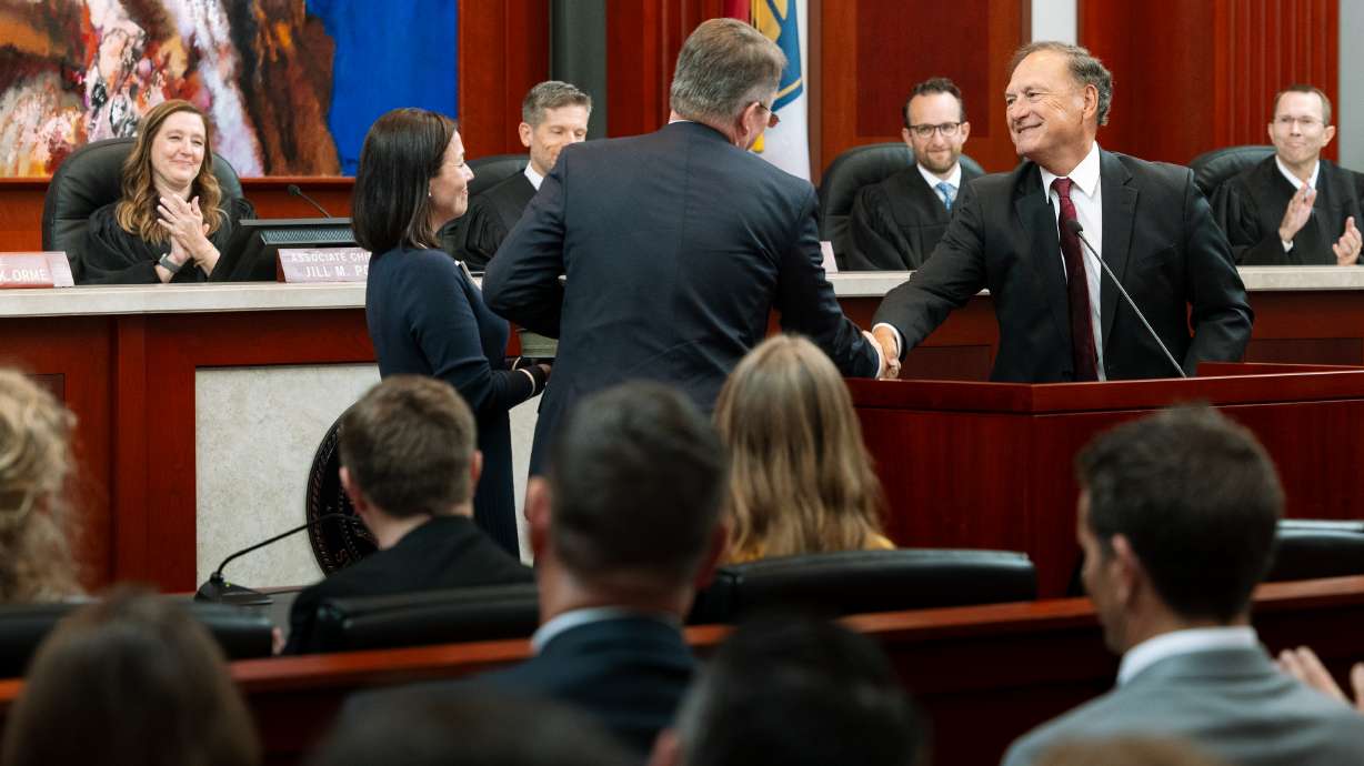 U.S. Supreme Court Justice Samuel Alito, right, shakes hands with Utah Supreme Court Justice Jay Jorgensen at his ceremonial swearing-in in the Supreme Court chambers in Salt Lake City on Monday, as other members of the Utah Supreme Court look on.
