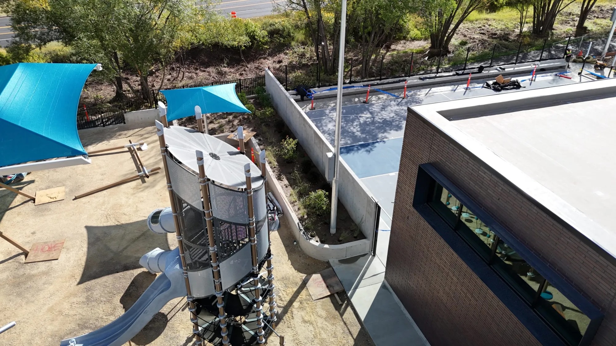 A concrete wall that separates a basketball court and playground at The Mine at City Park in Park City is under debate for obstructing views.