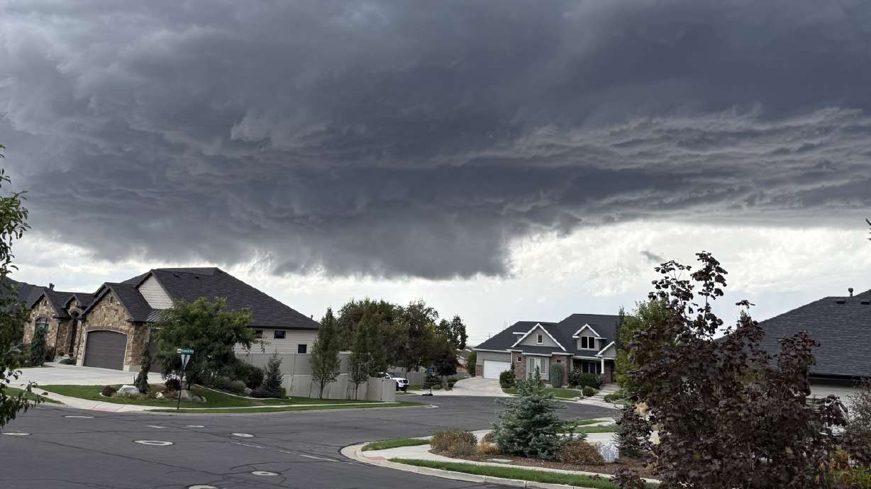 A storm is pictured above a neighborhood in Fruit Heights on Friday. Students in the Davis School District are still reeling from Friday's dramatic weather events, when hail and a tornado warning hit just after they had been released early from school.