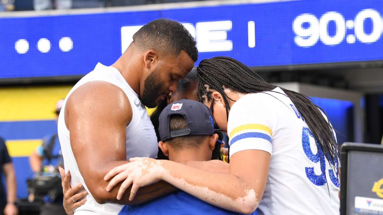 Los Angeles Rams defensive end Aaron Donald huddles with his family before an NFL football game against the New York Giants in Inglewood, Calif., Monday, Sept. 21, 2026.