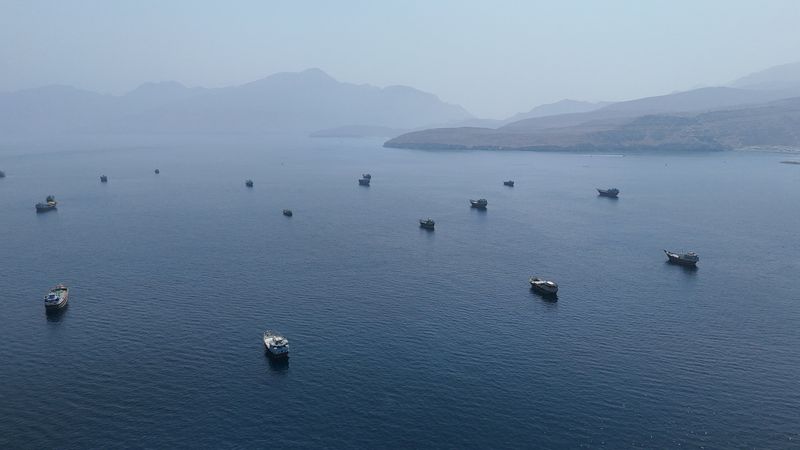 A drone view shows vessels near the Strait of Hormuz, as seen from Musandam, Oman, Aug. 28. The reopening of the strait is seen as the top priority in a deal to end the U.S.-Iran war.