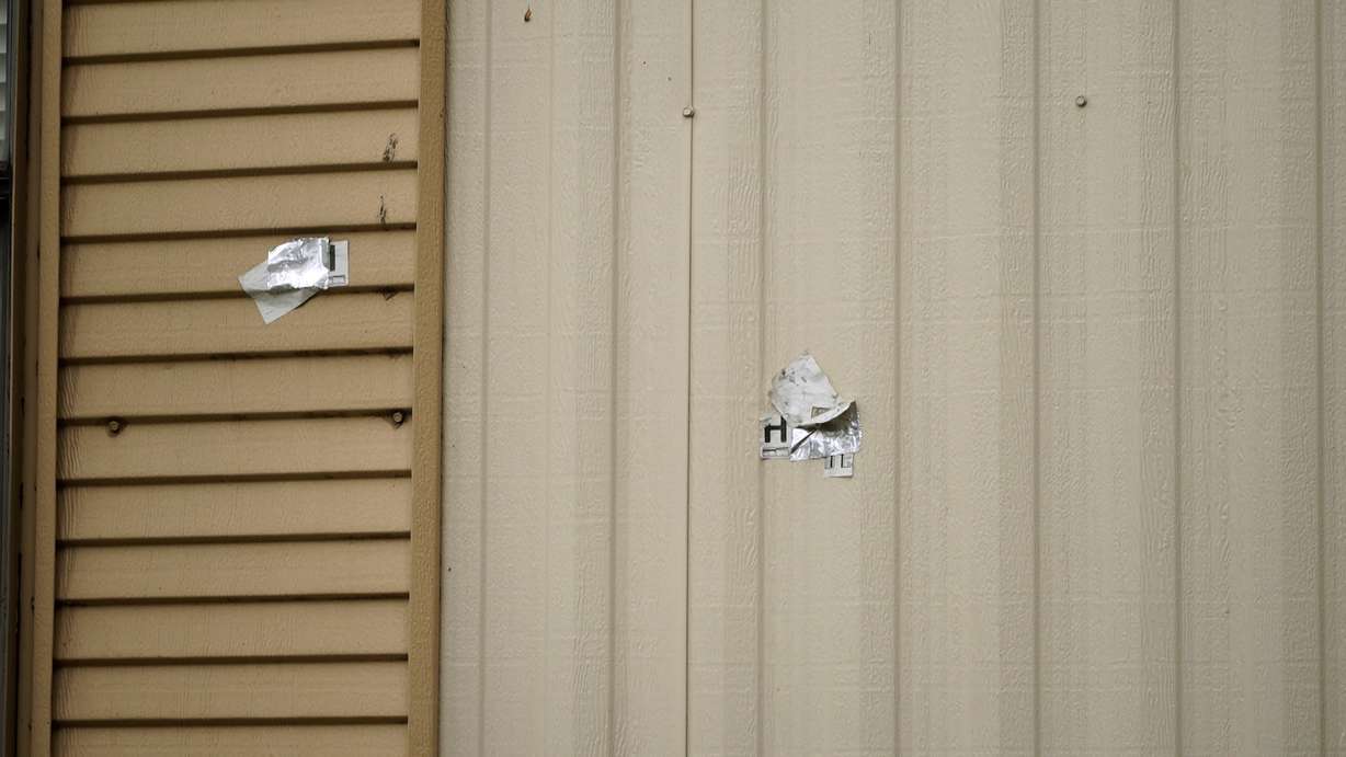 Bullet holes and evidence markers remain visible more than a year after the deadly incident.
