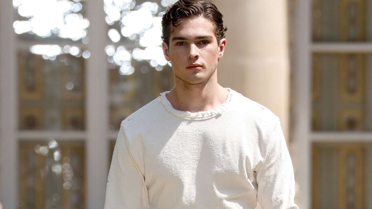 Clavicular, pictured modeling at Paris Fashion Week in June, has been charged with rape, drugging a person for sex and procuring alcohol for an underage person.
