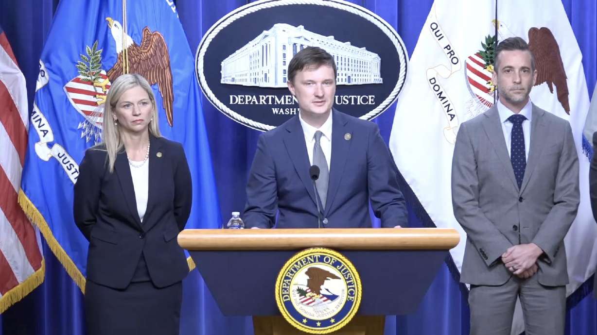 Acting deputy attorney general Trent McCotter, center, speaks at a press conference Tuesday announcing the indictment of a Utah postal worker accused of throwing away ballots. He is flanked by U.S. Attorney Melissa Holyoak for the District of Utah and Homeland Security Investigations deputy executive associate director Matthew Millhollin.