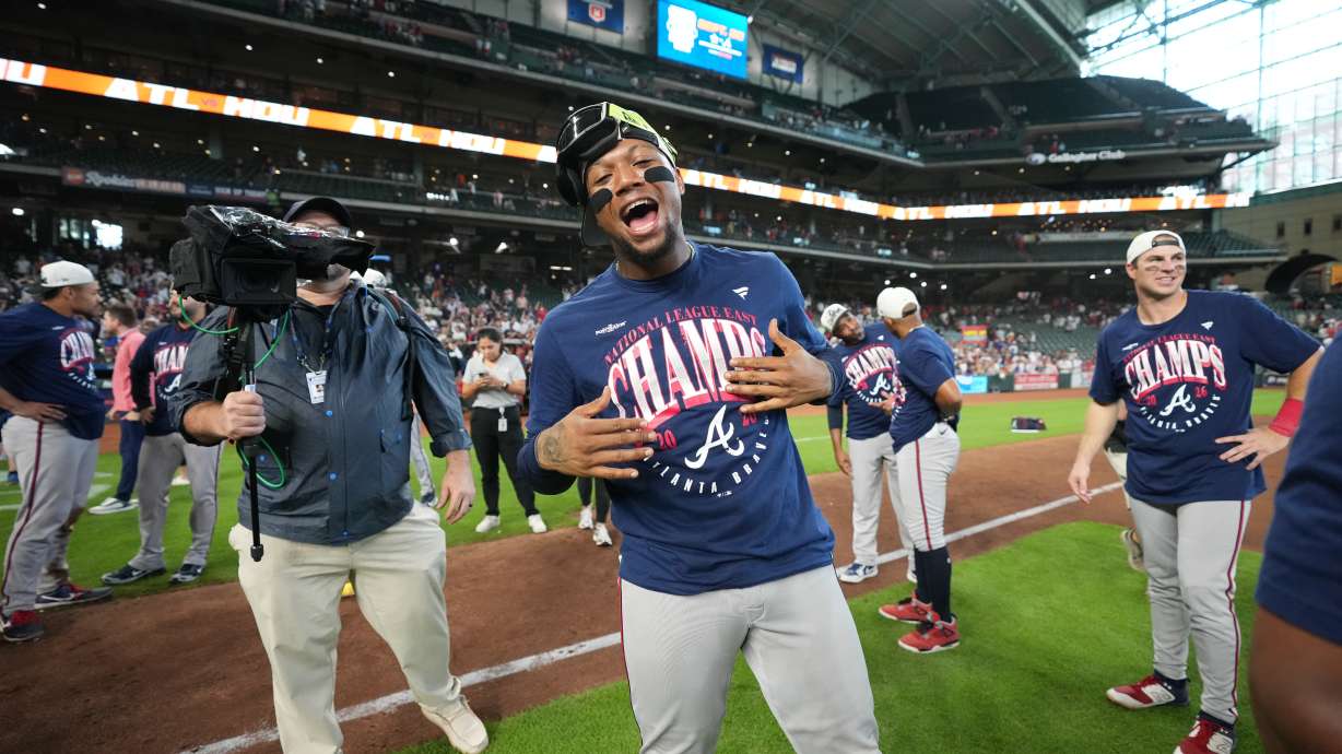 Atlanta Braves' Ronald Acuna Jr., center, celebrates on the field after a baseball game against the Houston Astros as the Braves clinched the NL East title, Sunday, Sept. 20, 2026, in Houston.