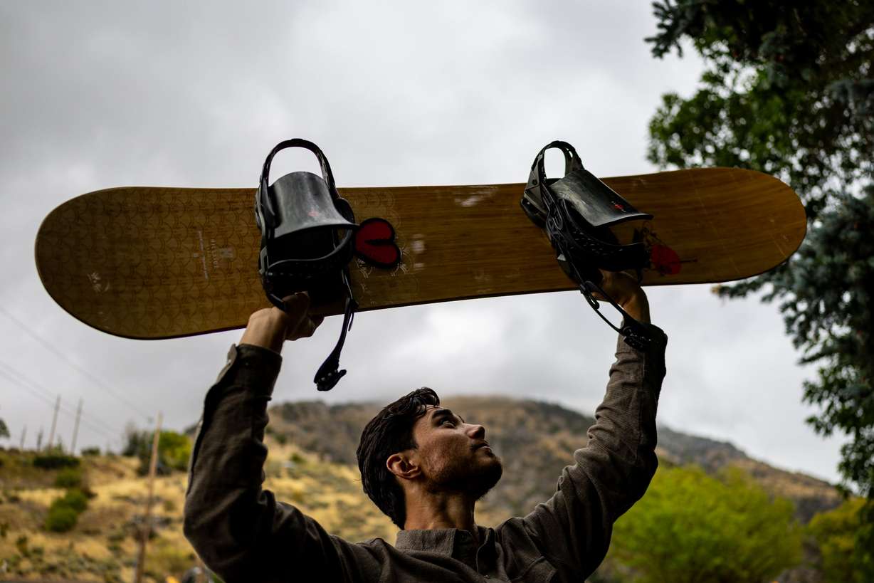 Clint Richins, who is looking at the feasibility of building a publicly owned ski resort, poses with his snowboard at River Hollow Park in Logan Canyon in Logan on Sept. 18.