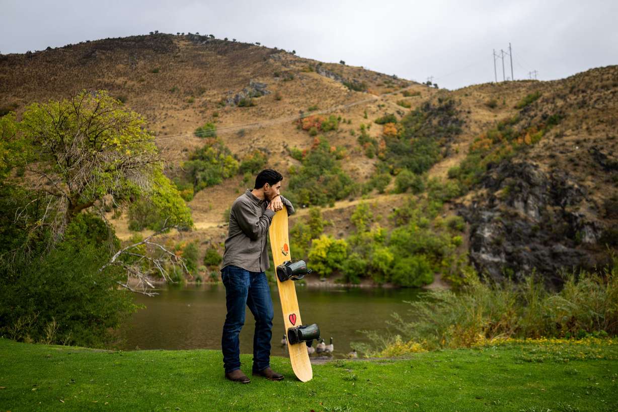Clint Richins, who is looking at the feasibility of building a publicly owned ski resort, poses with his snowboard at River Hollow Park in Logan Canyon in Logan on Sept. 18.