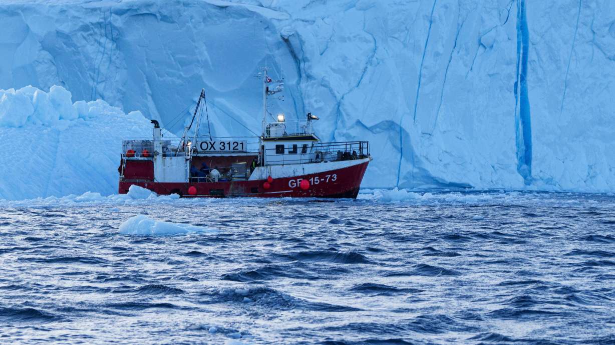 A fishing boat pulls a net up with fish in front of an iceberg at Disko Bay near Ilulissat, Greenland, on Jan. 29. President Donald Trump's agreement on Greenland made on Tuesday will matter more than just an increased military presence.