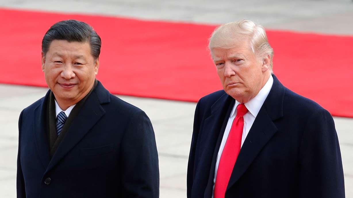 President Donald Trump walks with Chinese President Xi Jinping during a welcome ceremony at the Great Hall of the People in Beijing, Nov. 9, 2017. Xi is expected to receive a rare planeside welcome from Trump in Washington on Wednesday.
