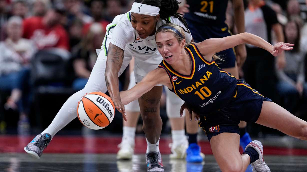 Indiana Fever guard Lexie Hull (10) and Minnesota Lynx forward Liatu King go for a loose ball in the first half of a WNBA basketball game in Indianapolis, Tuesday, Sept. 22, 2026.