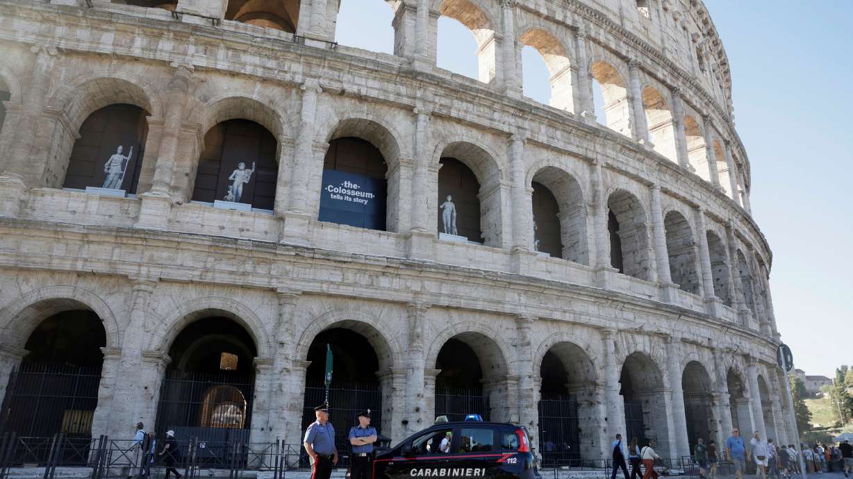 Carabinieri paramilitary police stand on patrol outside the Colosseum, closed to the public for the day to mourn a worker who fell to his death late Tuesday when installing cabling inside the ancient amphitheater, in Rome, Wednesday.