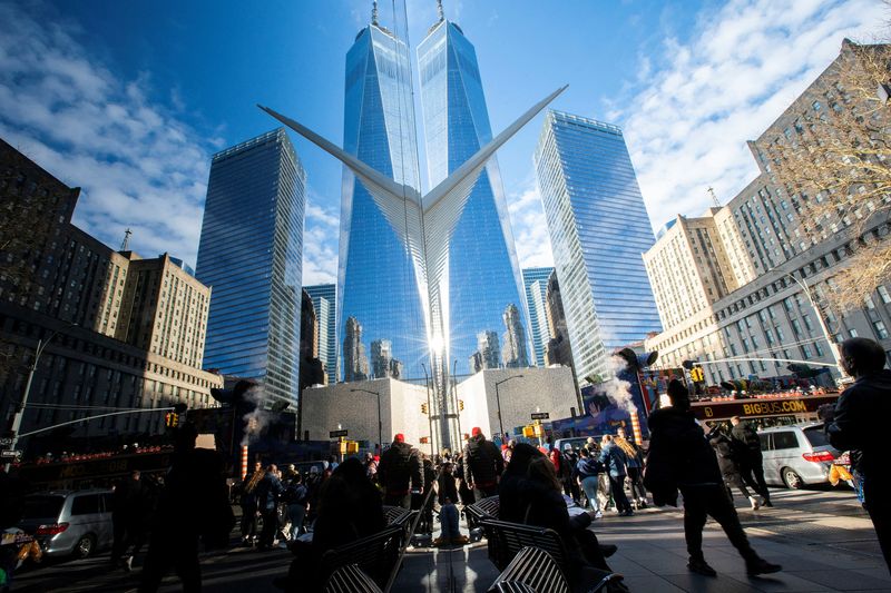 People walk around the Financial District near the New York Stock Exchange (NYSE) in New York, U.S., December 29, 2023.