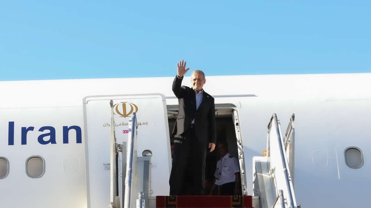 President Masoud Pezeshkian waves to media and officials as he boards his plane while leaving Mehrabad airport for New York to attend the United Nations General Assembly, in Tehran, Tuesday. Pezeshkian is expected to speak at the U.N. on Wednesday.