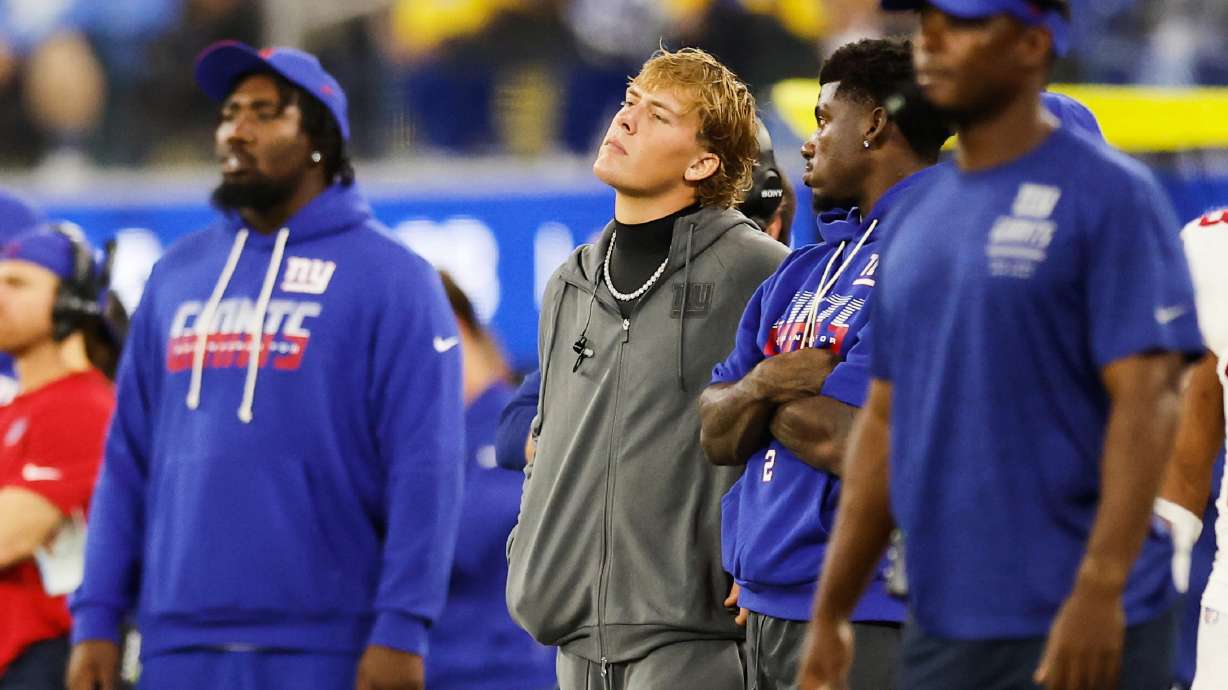 New York Giants quarterback Jaxson Dart, center, watches from the sideline during the second half of an NFL football game against the Los Angeles Rams in Inglewood, Calif., Monday, Sept. 21, 2026.