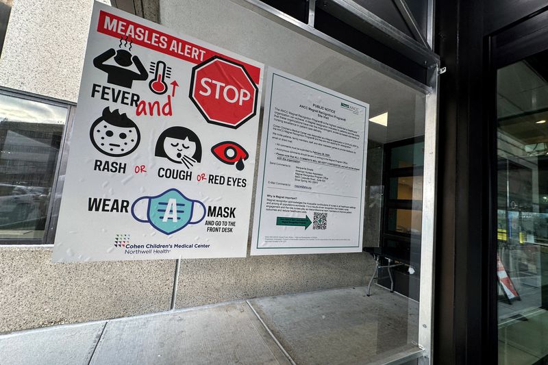 FILE PHOTO: A measles alert sign hangs outside the entrance to the Cohen Children's Medical Center in New Hyde Park, New York, U.S., March 14, 2025.