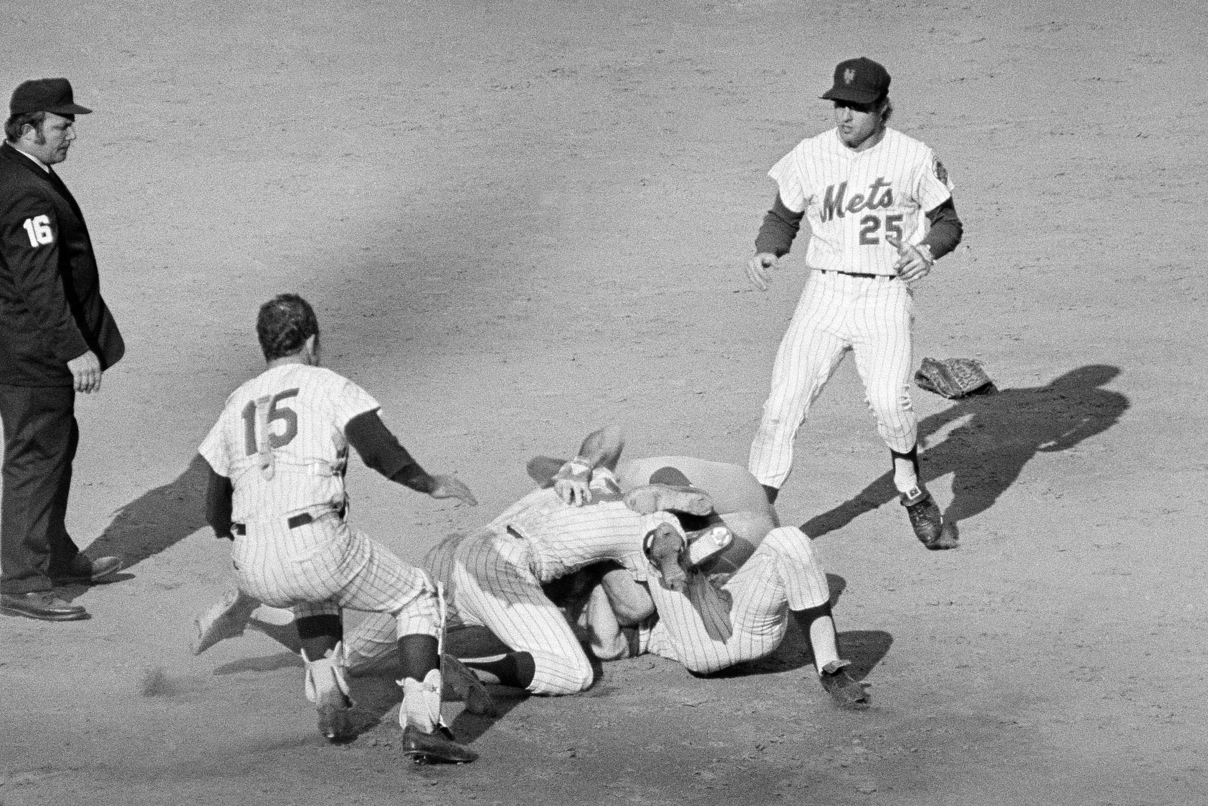 FILE - Pete Rose of the Cincinnati Reds (14) and Bud Harrelson (3) of the New York Mets engage in a tussle after double play action during the fifth inning of the third National League playoff game in New York, Oct. 8, 1973. 