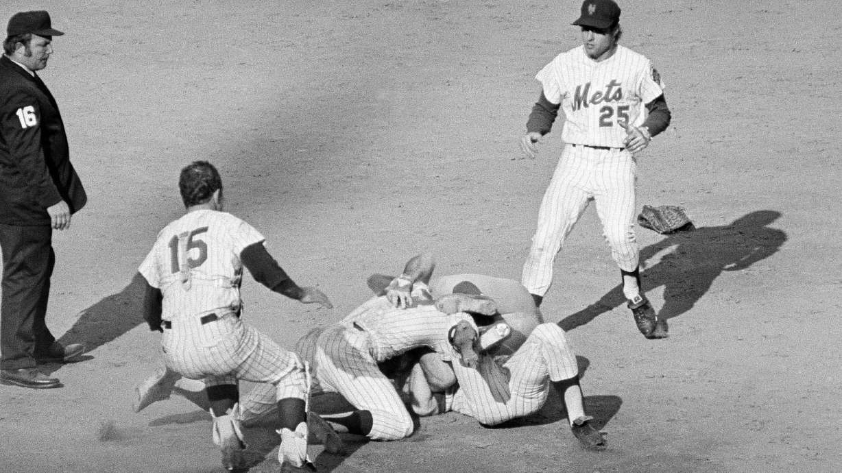 FILE - Pete Rose of the Cincinnati Reds (14) and Bud Harrelson (3) of the New York Mets engage in a tussle after double play action during the fifth inning of the third National League playoff game in New York, Oct. 8, 1973.