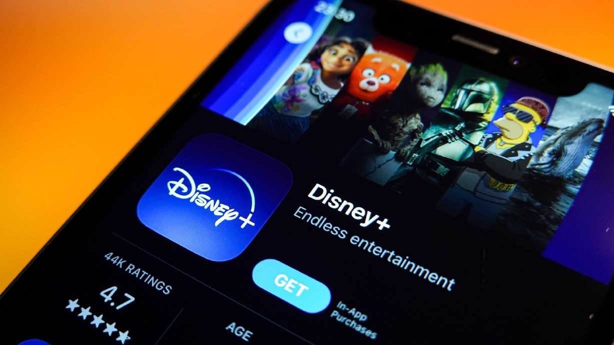 In this photo illustration, the Disney+ logo is displayed in the Apple App Store on an iPhone.