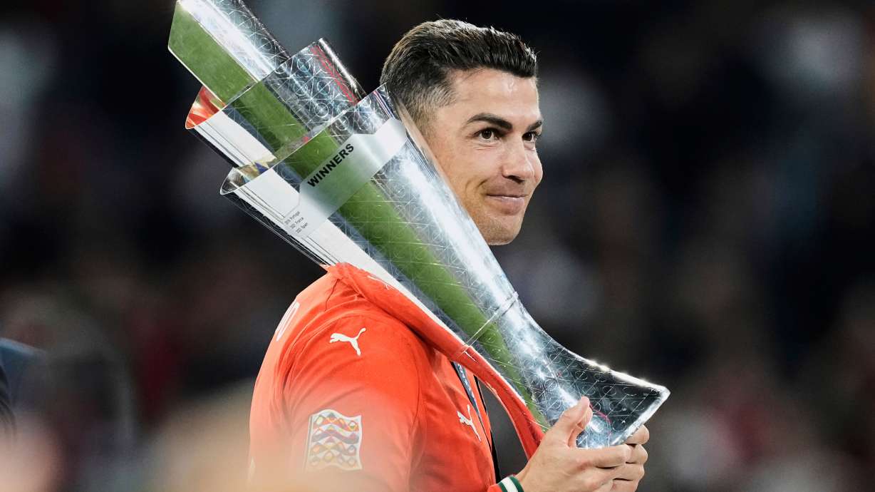 FILE - Portugal's Cristiano Ronaldo holds the trophy after winning the Nations League soccer championship at the Allianz Arena in Munich, Germany, Sunday, June 8, 2025.