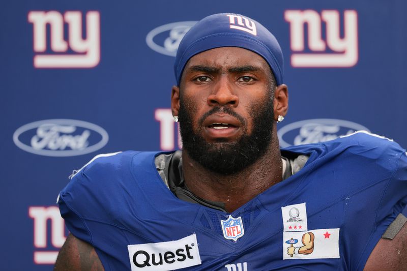 Aug 20, 2026; Miami Gardens, FL, USA; New York Giants linebacker Brian Burns (0) speaks to reporters after joint practice with the Miami Dolphins at Baptist Health Training Complex.