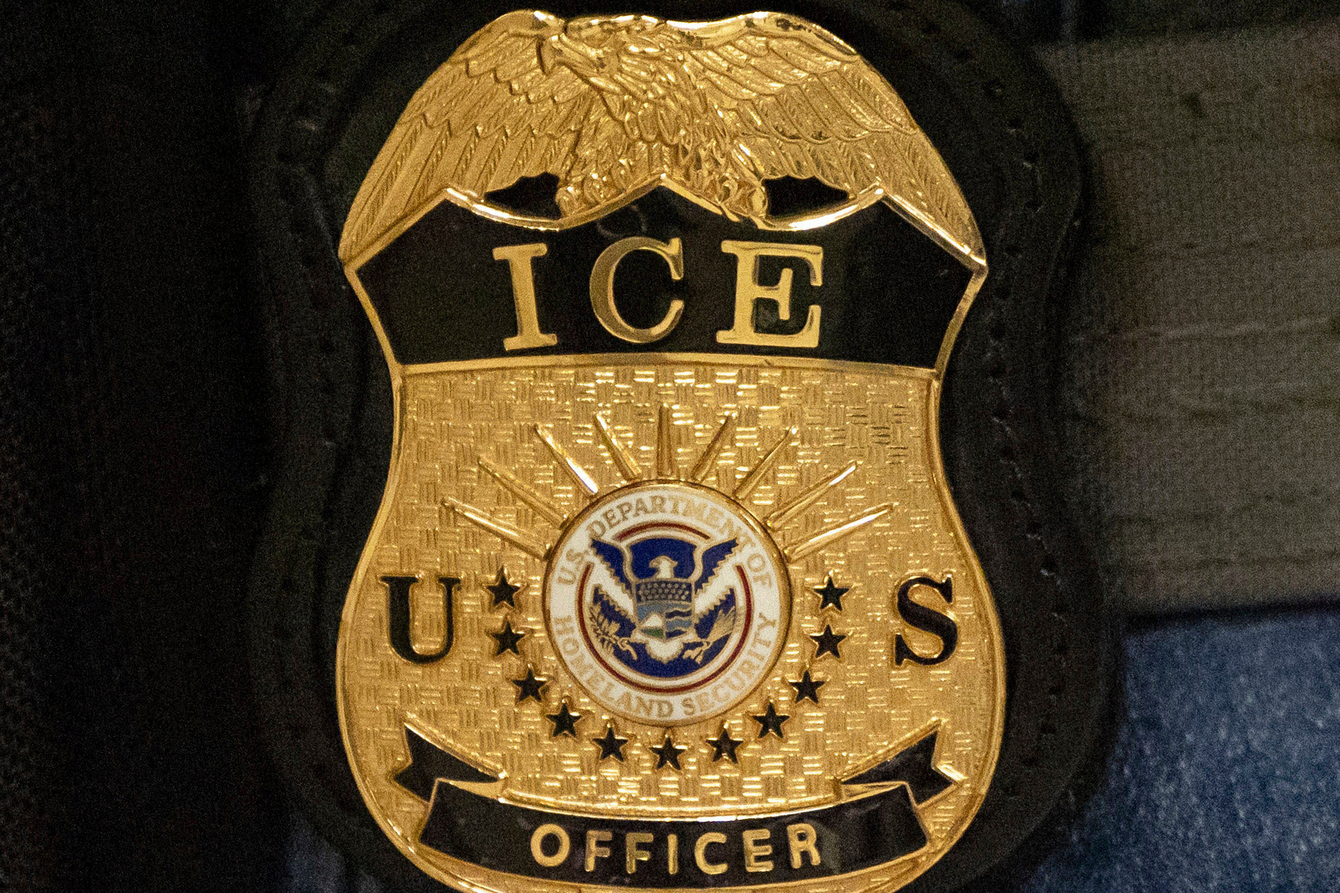 FILE - A federal agent wears an Immigration and Customs Enforcement badge in New York, June 10, 2025. 