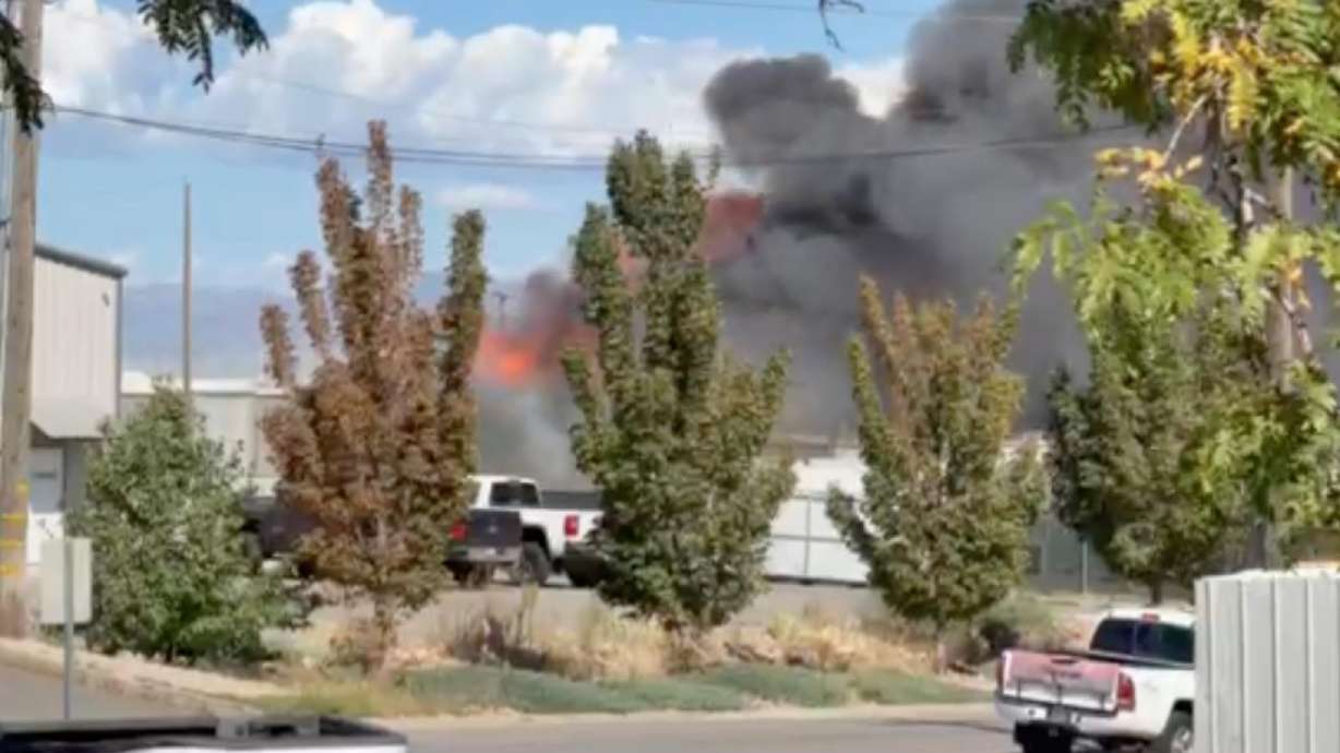 A commercial structure fire is seen burning in West Jordan on Wednesday. A firefighter was injured as he fought a commercial structure fire in West Jordan Wednesday afternoon.