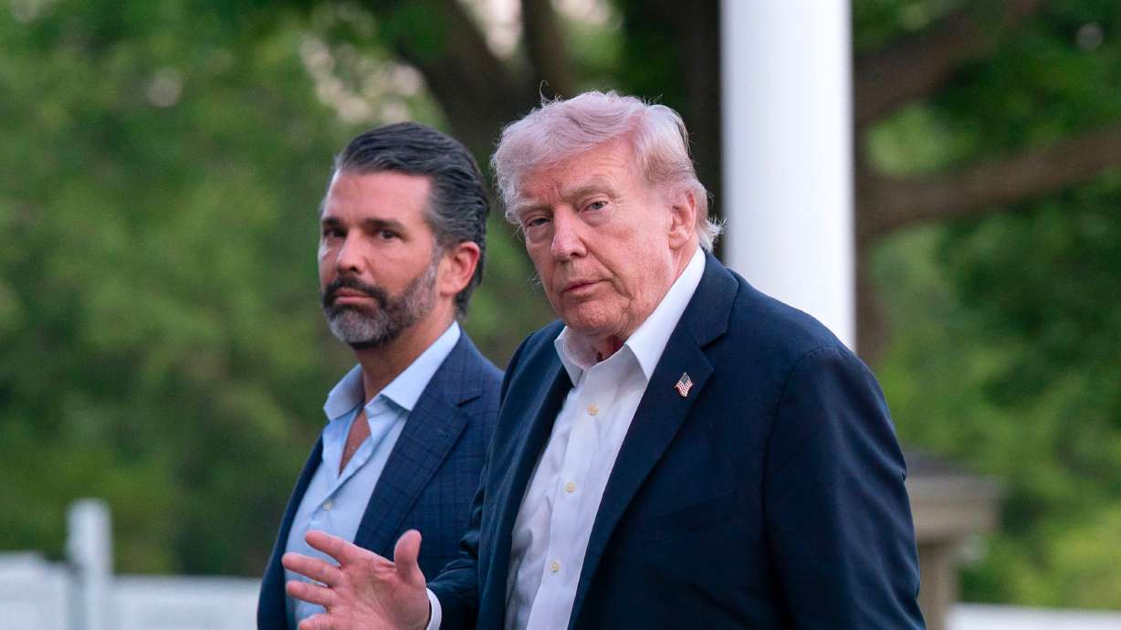 President Donald Trump and Donald Trump Jr. walk on the South Lawn upon their arrival to the White House, May 3. Congressional Republicans are split on Sen. John Curtis' request to subpoena Trump Jr. and Hunter Biden.